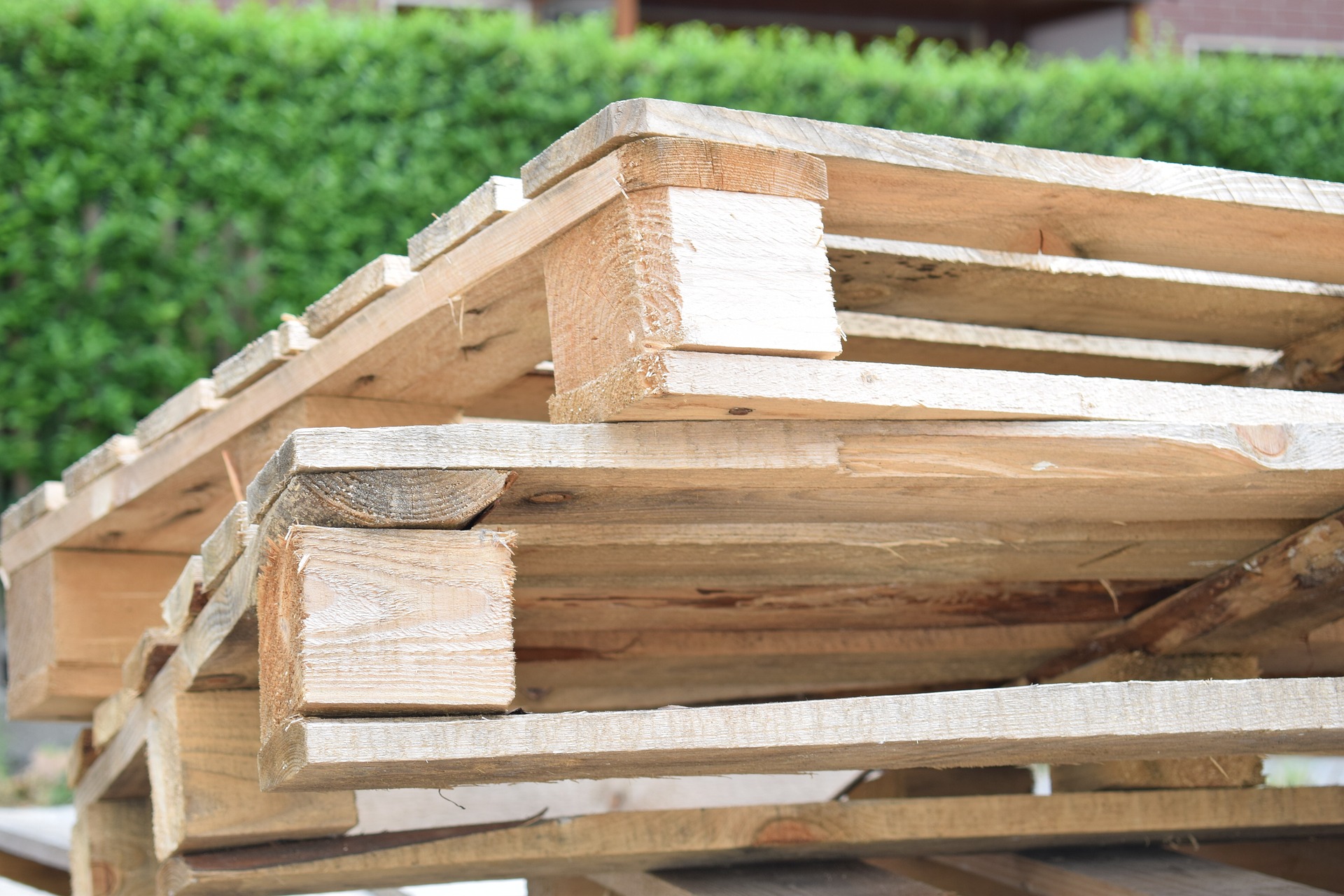 An upcycled coffee table made from reclaimed wood pallets placed in a stylish living room setting.